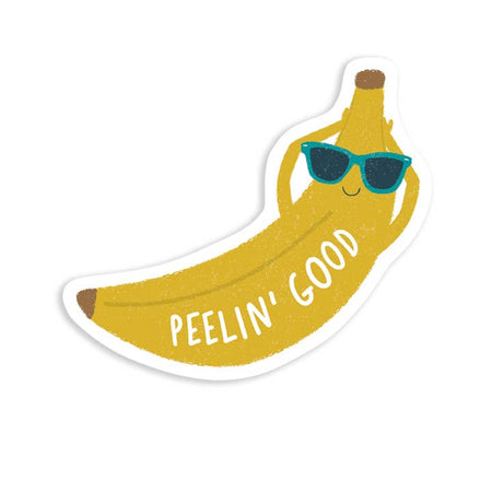 Sticker in the image of a yellow banana relaxing with arms behind head and wearing blue sunglasses. White text saying, “Peelin’ Good”.