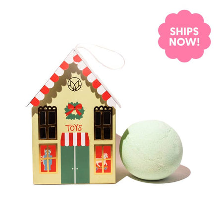 Green soap balls wrapped in a box in the image of a village toy shop.