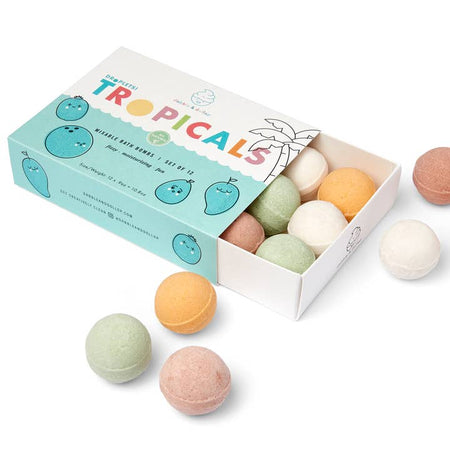 Multicolored bath balls packaged in a white box with water and wave background with muted images of fruits. Rainbow text saying, “Tropicals Mixable Bath Bombs”.