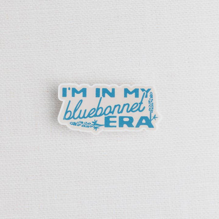 Sticker with images of bluebonnet flowers and blue text saying, “I’m in My Bluebonnet Era”.
