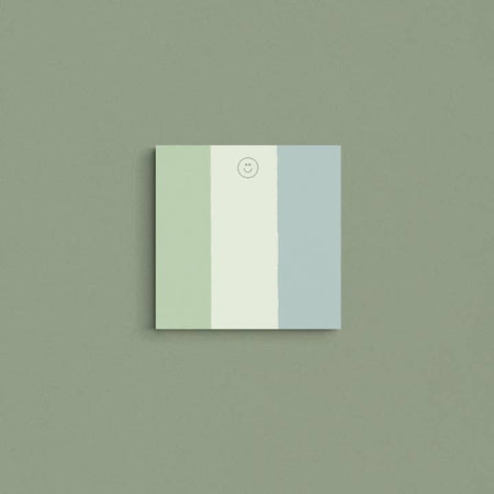 Square pad with dark green, mint green and slate blue vertical stripes and a smiley face in the top center.