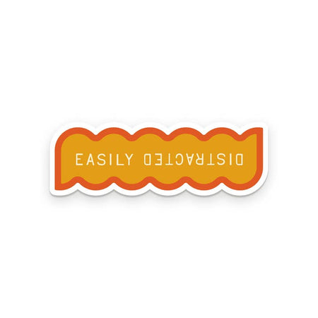 White sticker with orange inlay and orange border. White text saying, 