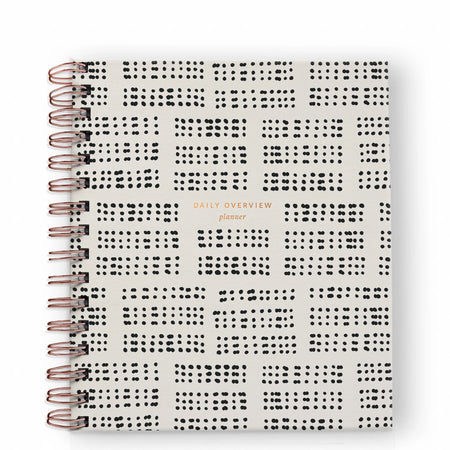 Ivory notebook with black dots across front with gold foil text saying, 