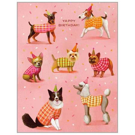 Pink card with various dogs dressed in sweaters wearing birthday party hats. Red text saying, “Yappy Birthday!” A matching envelope is included.