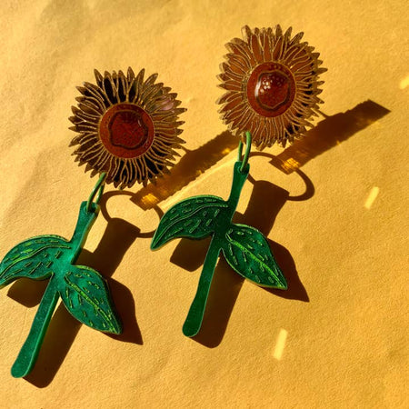 Set of earrings in the image of yellow sunflower plants.