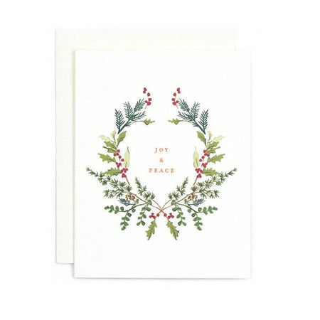 White card with floral border of holly leaves and red holly berries. Gold foil text saying, 