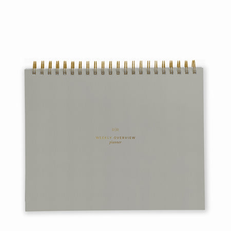 Charcoal gray notebook with gold foil text saying, 