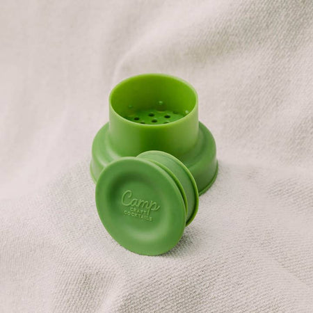 Green strainer with lid and cap with holes to strain cocktails.