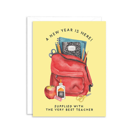 Yellow card with black text saying, “A New Year is Here! Supplied With the Very Best Teacher”. Image of a red backpack filled with school supplies. A white envelope is included.