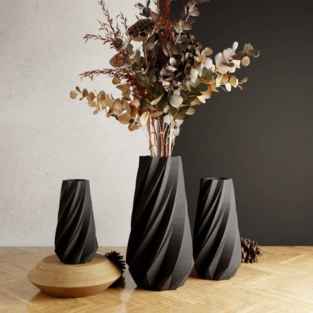 Black vase with vertical slanted contoured lines.