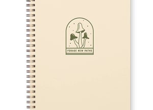 Ivory notepad with green arch in center with images of green mushrooms with green text saying, 