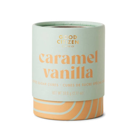 Light green circle container with orange text saying, “Good Citizen Caramel Vanilla Sugar Cubes”. Orange swirl design on bottom of container.